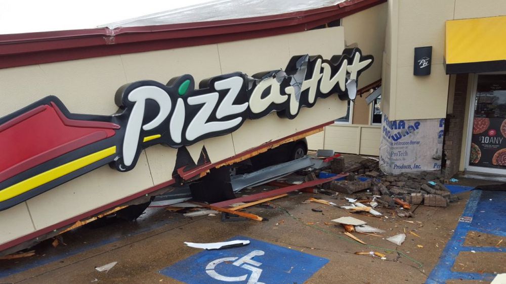Strong storms blow roof off Alexandria car wash and onto nearby Pizza Hut