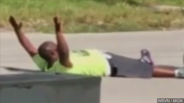 Police shoot autistic man's caretaker as he lies in street