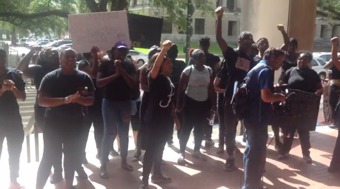 Protesters hold quick gathering at city hall Monday