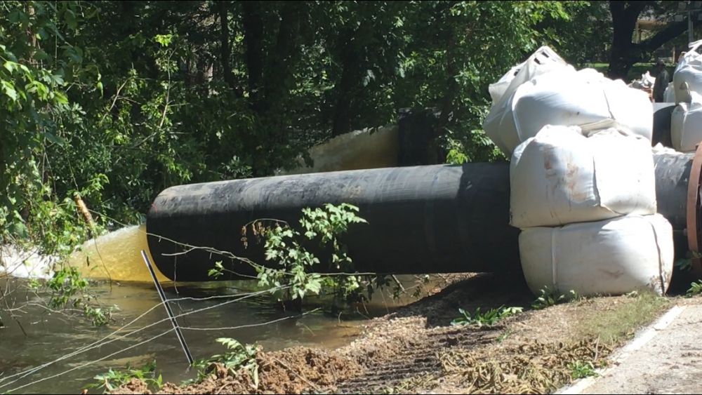 Crews begin cutting road to relieve flooding