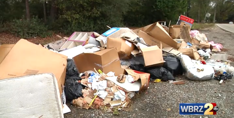 City officials working to remove trash pile from front of Central subdivision