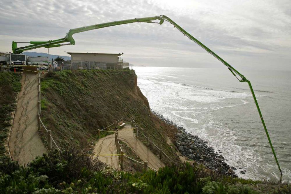 Concrete pumped into sinkhole on eroded California cliff