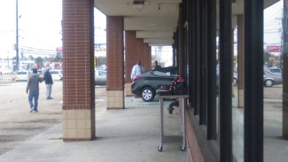 Car driven over curb, into building Monday