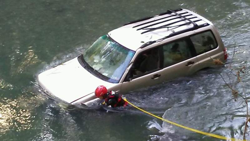 Woman and dog spend night trapped in crashed car in California creek