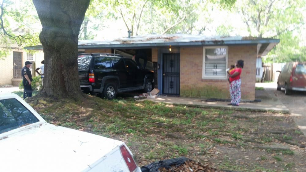 SUV drives through home on Rhodes Avenue