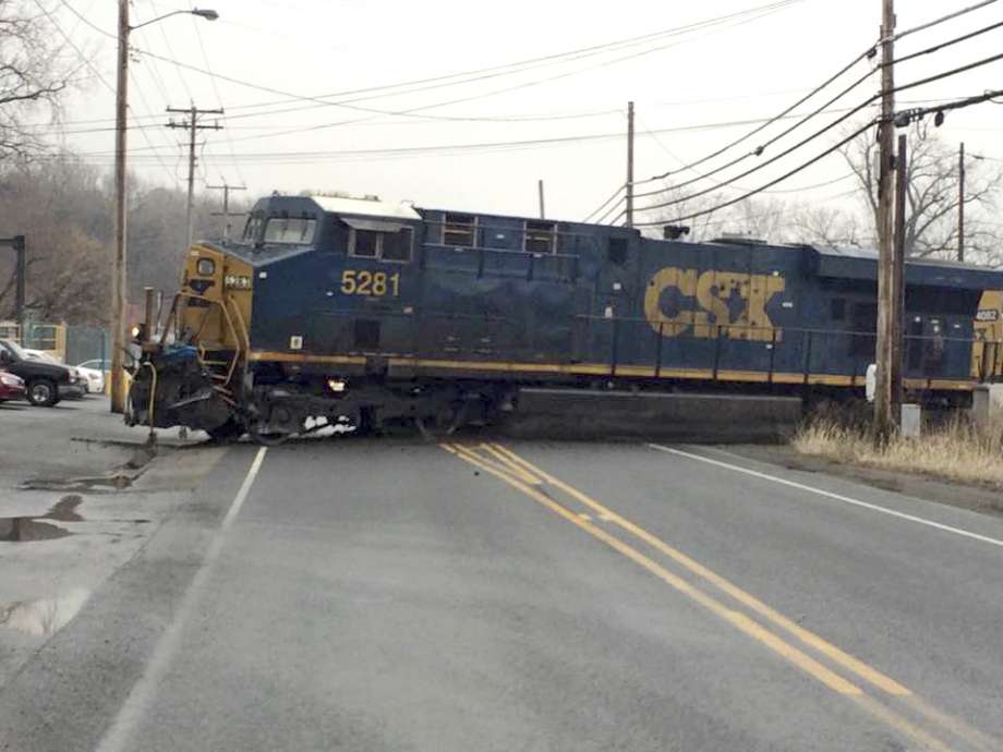 Freight train carrying hazardous materials derails, leaks