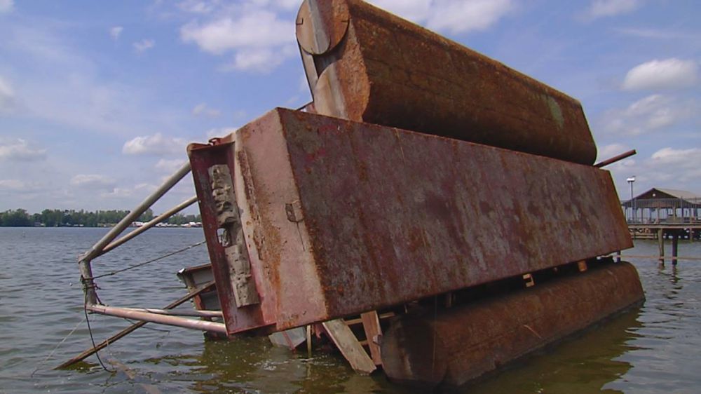 Large barge tipped over in False River, been there since August