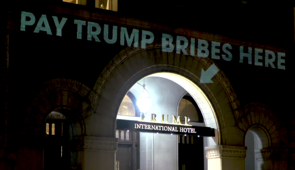 Artist projects words 'pay Trump bribes here' onto DC hotel