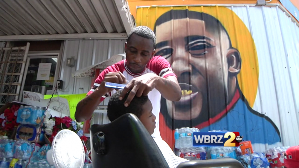 People gather outside Triple S convenience store one week after Alton Sterling shooting