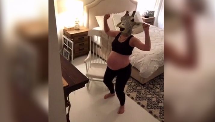 Pregnant mom struts around in giraffe mask, mocks viral video